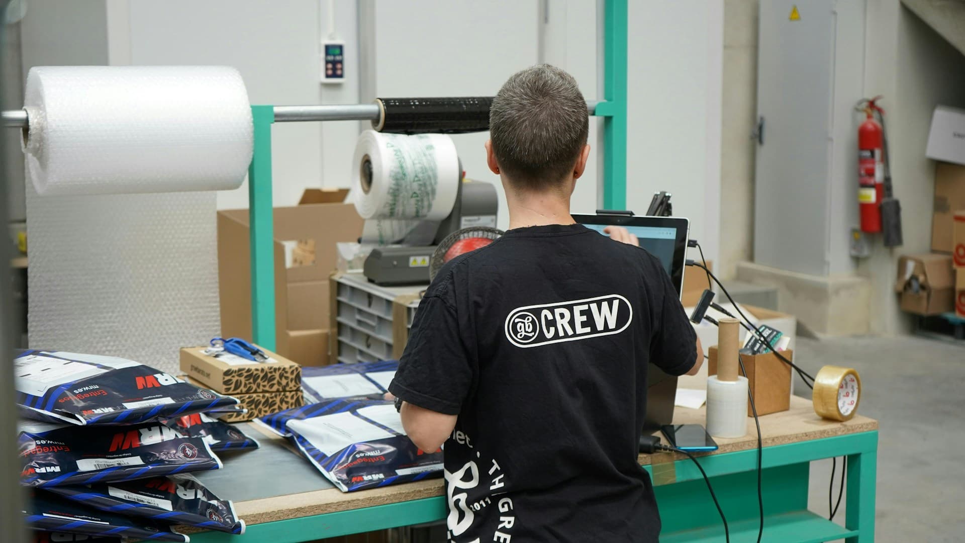 Worker checking packaged goods in a warehouse